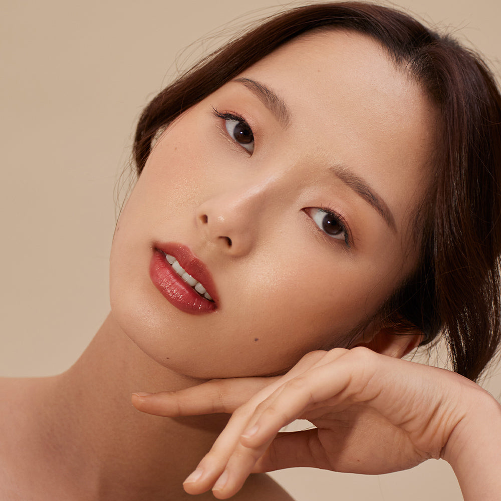 Close-up of a woman with a neutral background