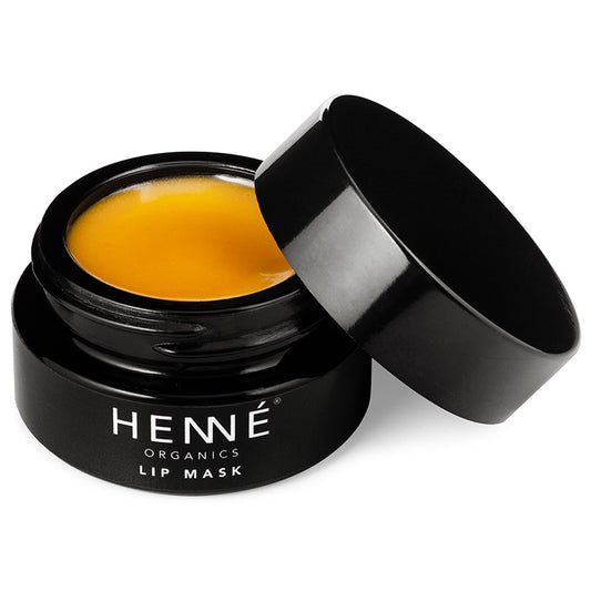Black jar of HENNE Organics lip mask with yellowish substance inside on a white background