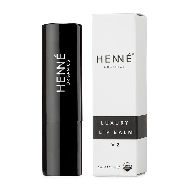 Black lip balm with Henne Organics packaging on a white background